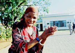 A Bushman woman dances in the street outside the court in Lobatse after the verdict